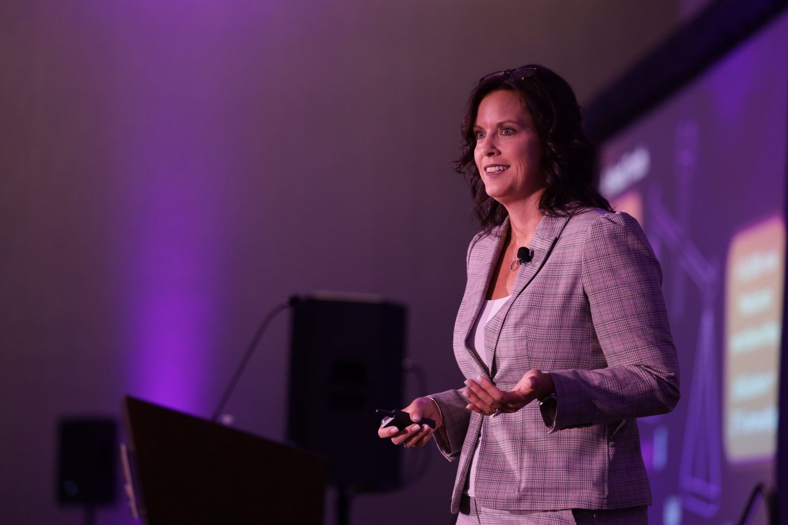 Speaker presenting on stage with a headset microphone