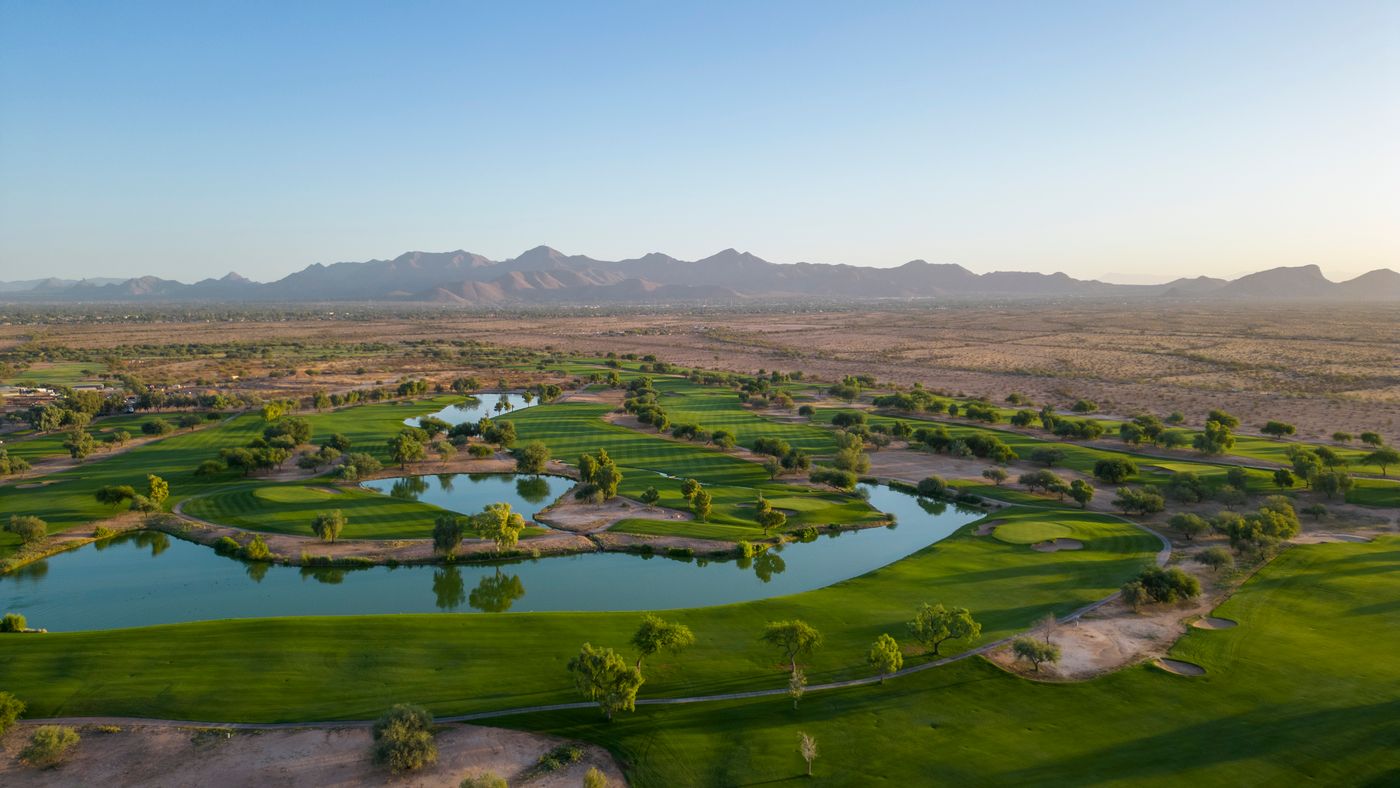 Aerial view of a green ringed by water at Talking Stick Golf Club